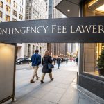 A street view with a sign reading "Contingency Fee Lawyers," representing legal services in New York.